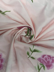 Close-up of pink fabric gathered around a stitched floral motif.