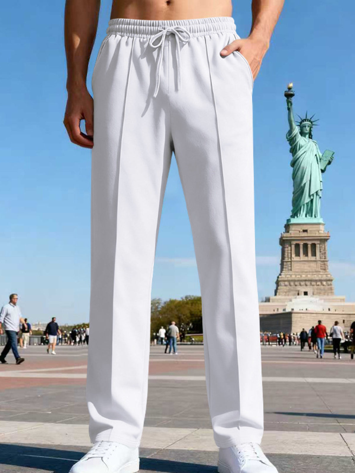 Back view of blue straight-leg pants on a model in a city setting.