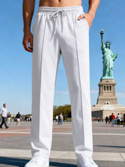 Back view of blue straight-leg pants on a model in a city setting.