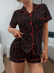 Black pajama shirt and shorts with red heart print and piping, back view