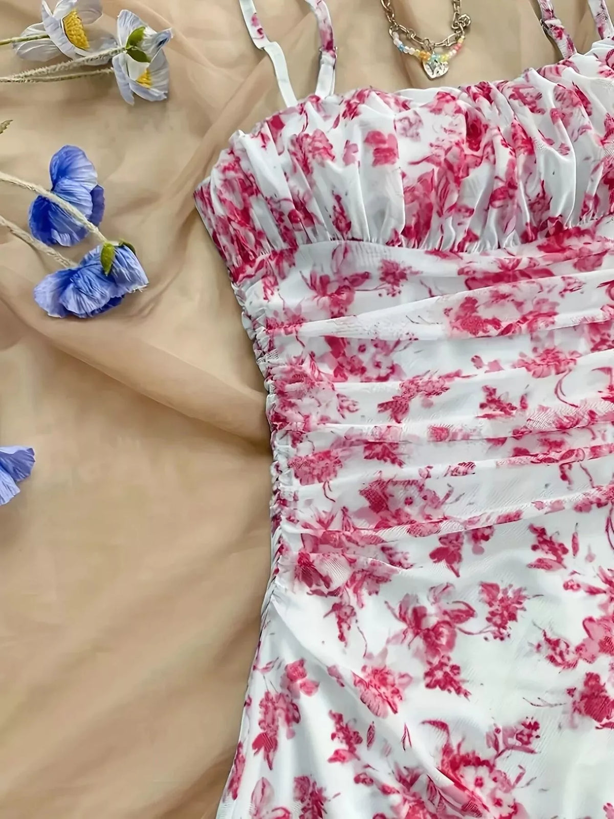 Close-up of ruched pink floral dress fabric and neckline