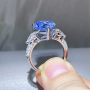 Side view of the raised blue heart stone and silver ring setting.