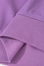 Close-up of purple ribbed sweatshirt cuff
