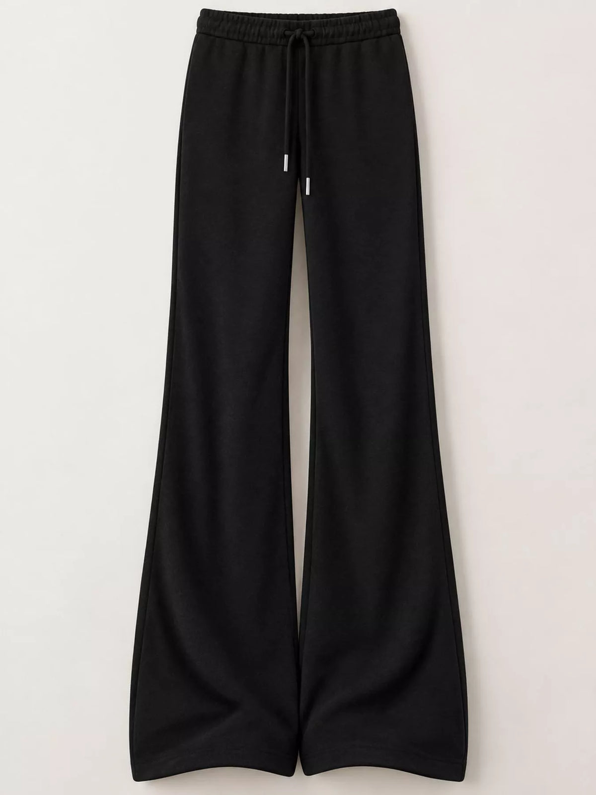 Black drawstring flare trousers displayed flat on white