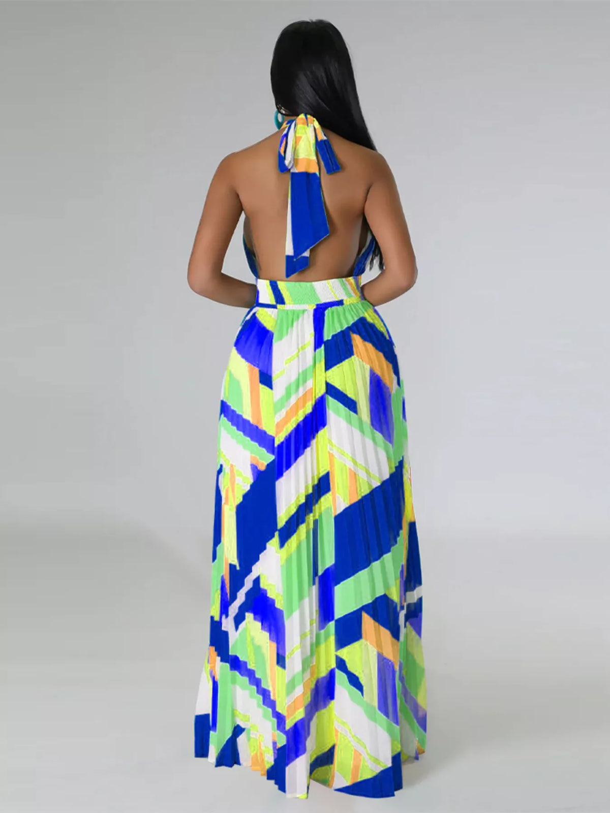 Straight back view of a blue and lime geometric maxi dress with a tied halter neck and open back.