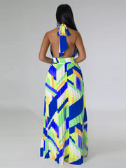 Straight back view of a blue and lime geometric maxi dress with a tied halter neck and open back.