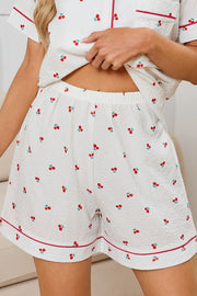 Cherry-Print Collared Top & Shorts Lounge Set: Close-up of cherry-print shorts with red piping and pockets.
