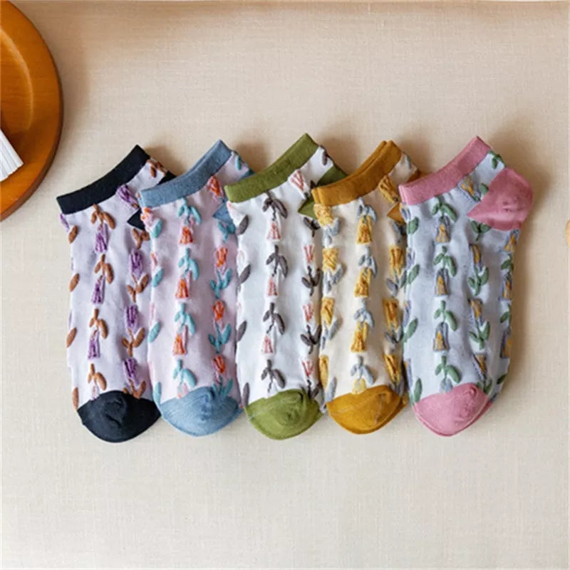 Five white floral ankle sock pairs with contrasting black, blue, green, yellow and pink trims