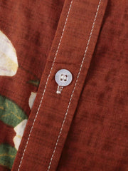 Close-up of rust shirt placket, stitching and button