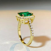 Side view of the gold-tone ring with a green rectangular center setting.