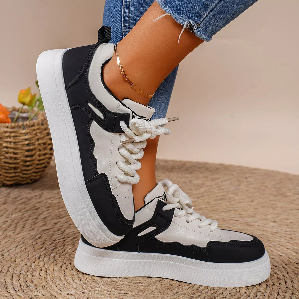 Side view of black and white platform lace-up sneaker