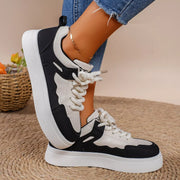 Side view of black and white platform lace-up sneaker