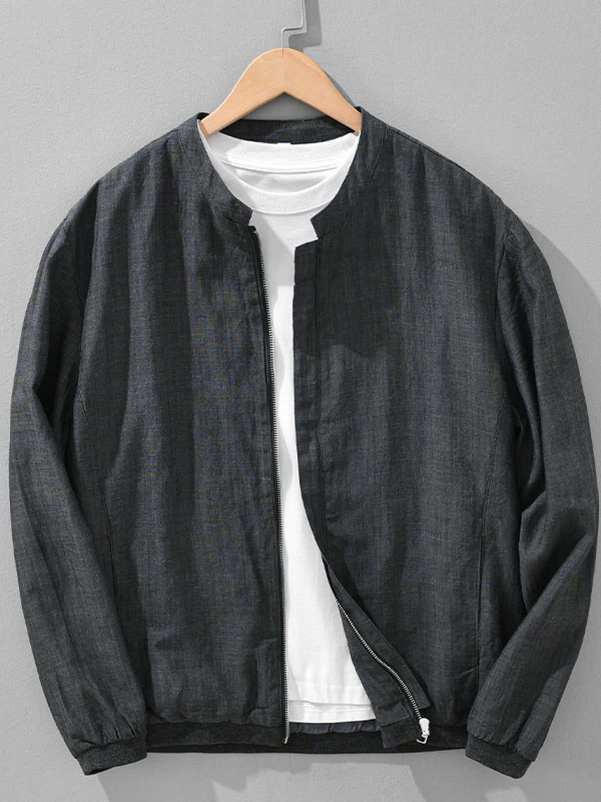 Black zip-up jacket layered over a white shirt
