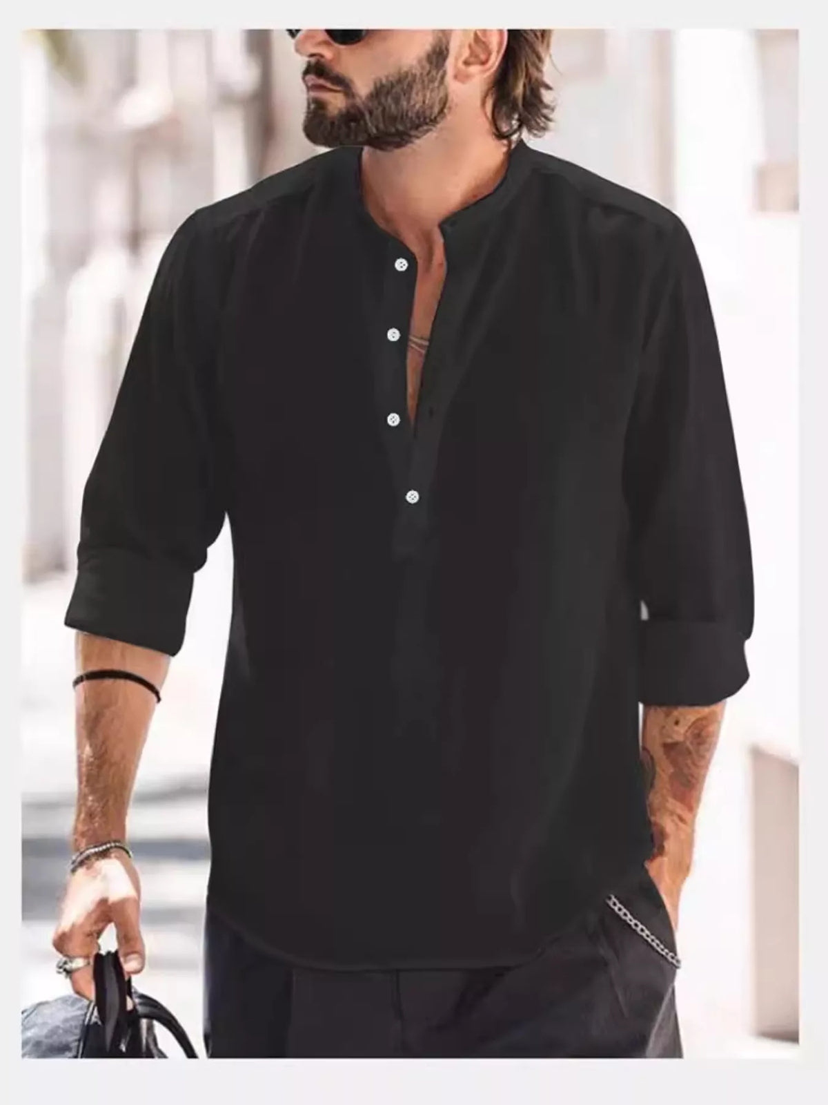 Model wearing a black long-sleeve shirt with a short button placket