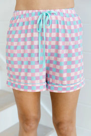 Close view of matching plaid lounge shorts with elastic waist