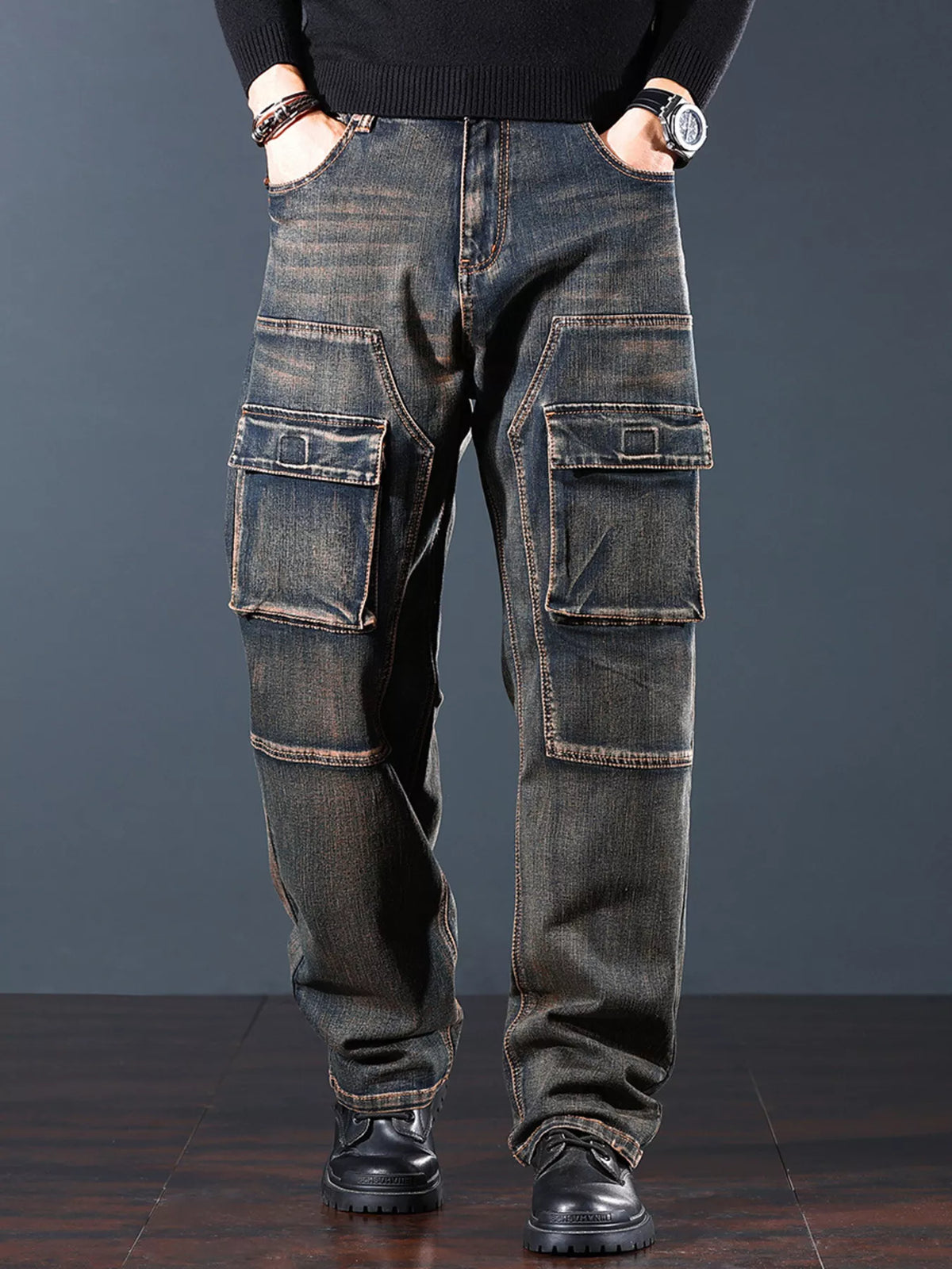 Front view of faded dark denim cargo jeans with flap pockets on both legs