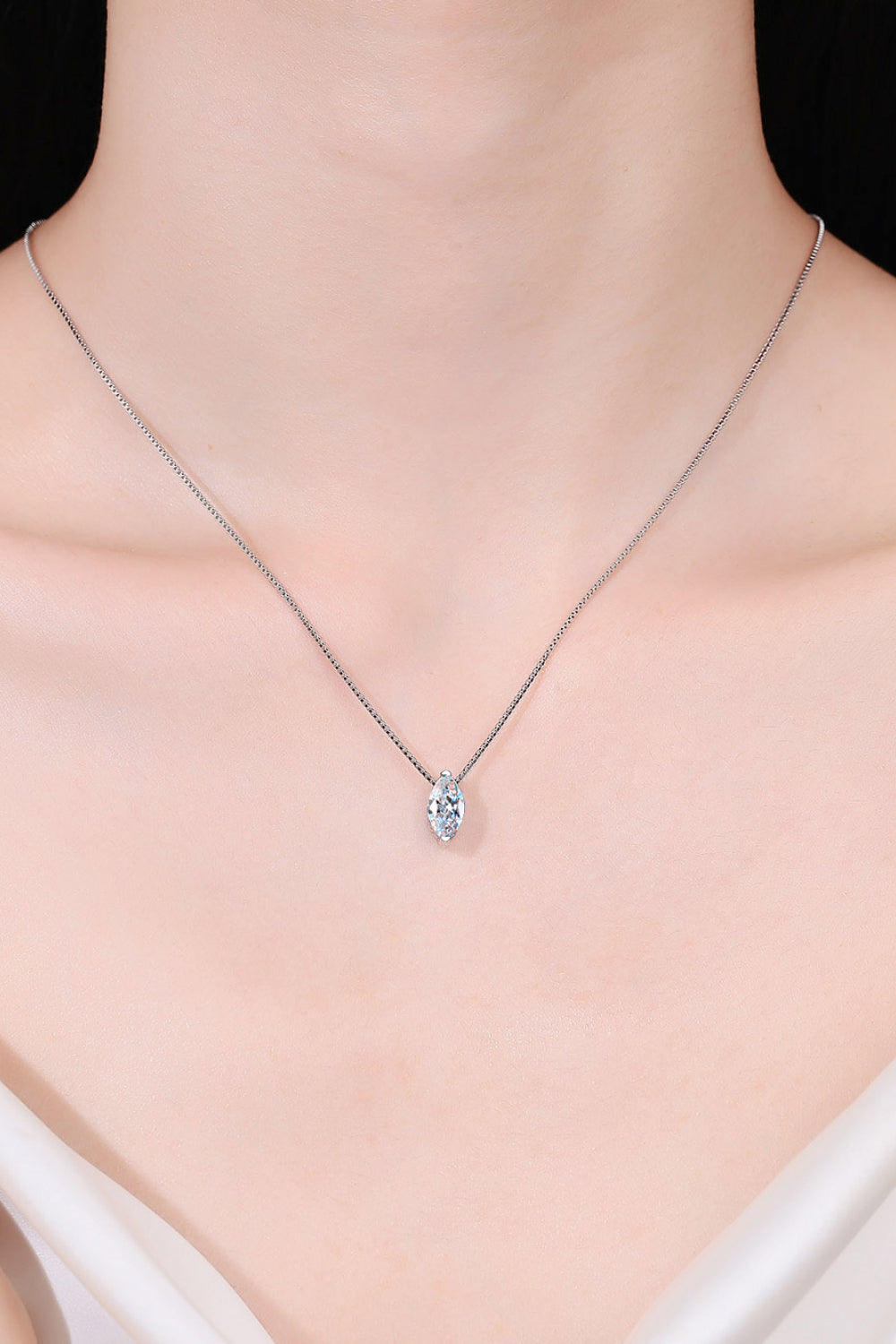 Model wearing a marquise-cut moissanite pendant necklace