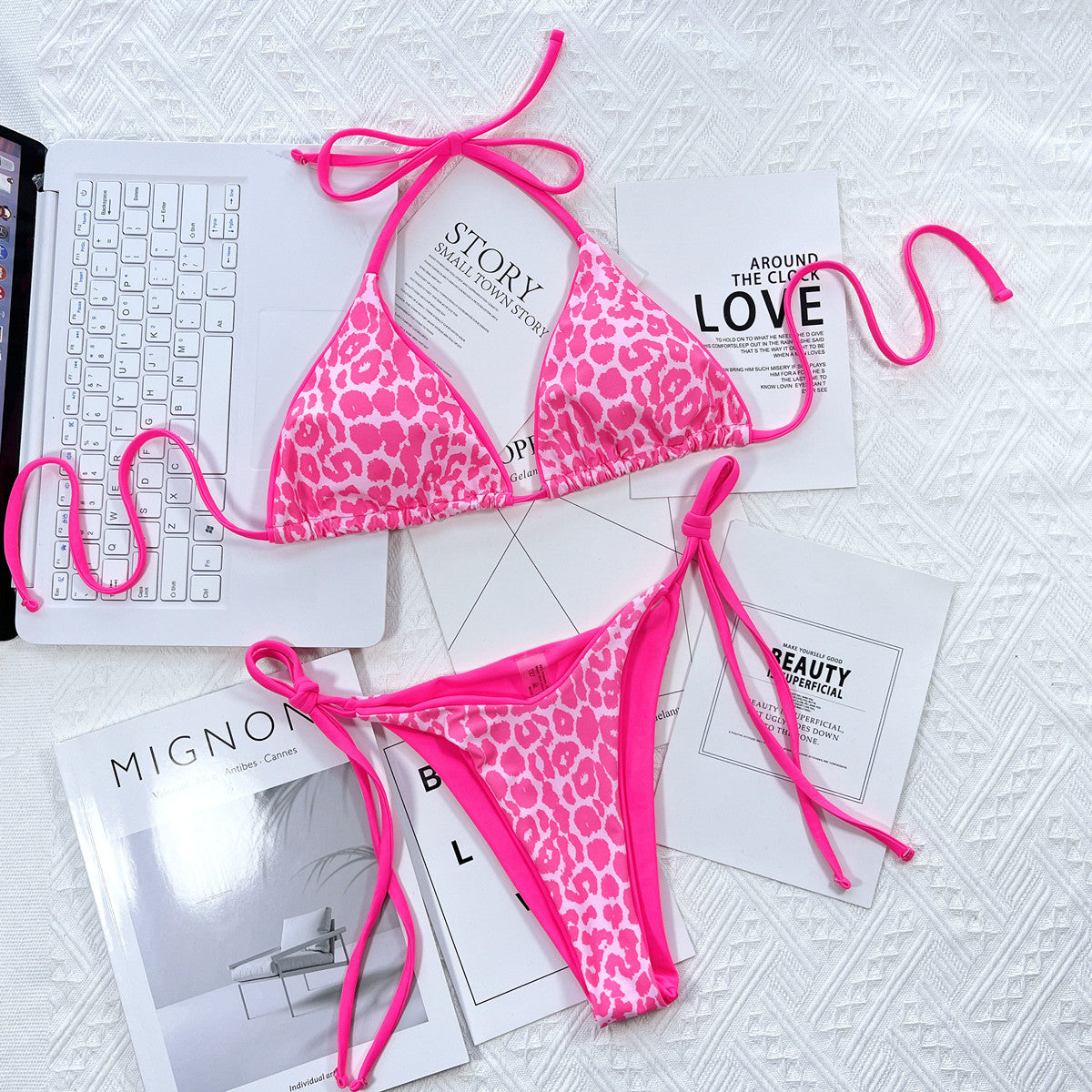 Pink leopard bikini bottoms with side ties laid flat