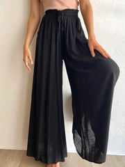 Close-up of black wide-leg pants with a gathered waist
