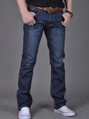 Model wearing dark blue slim-fit jeans, front view with hands at pockets