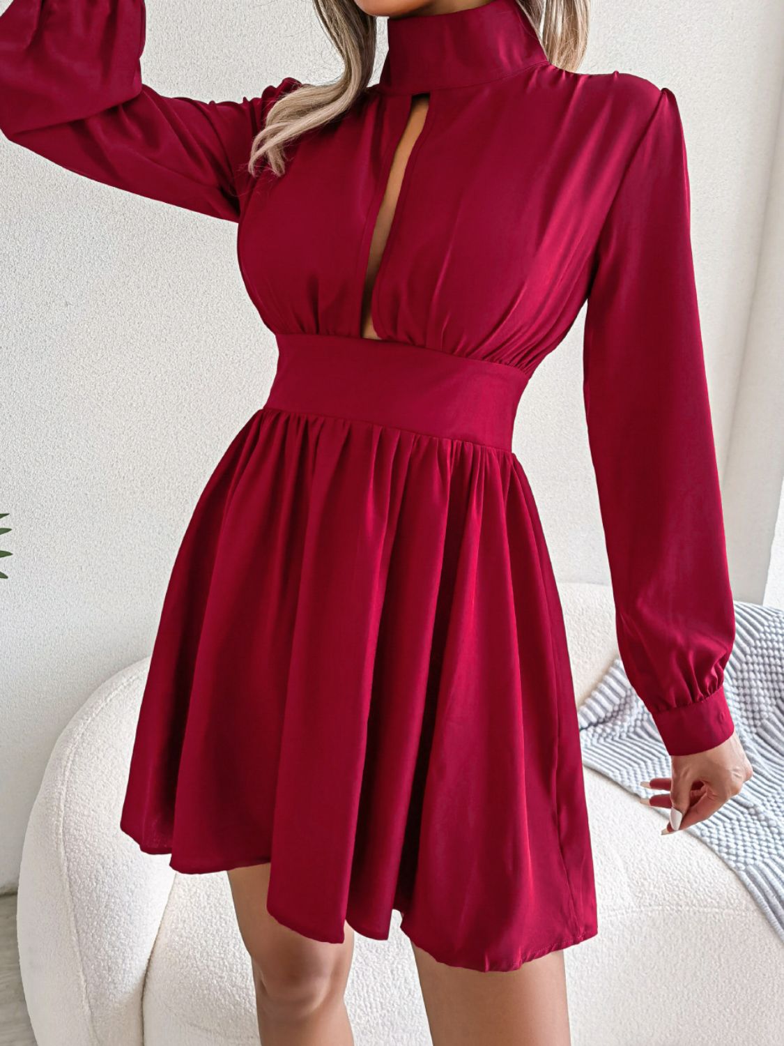 Front detail of burgundy cutout neckline and long sleeves on the A-line mini dress