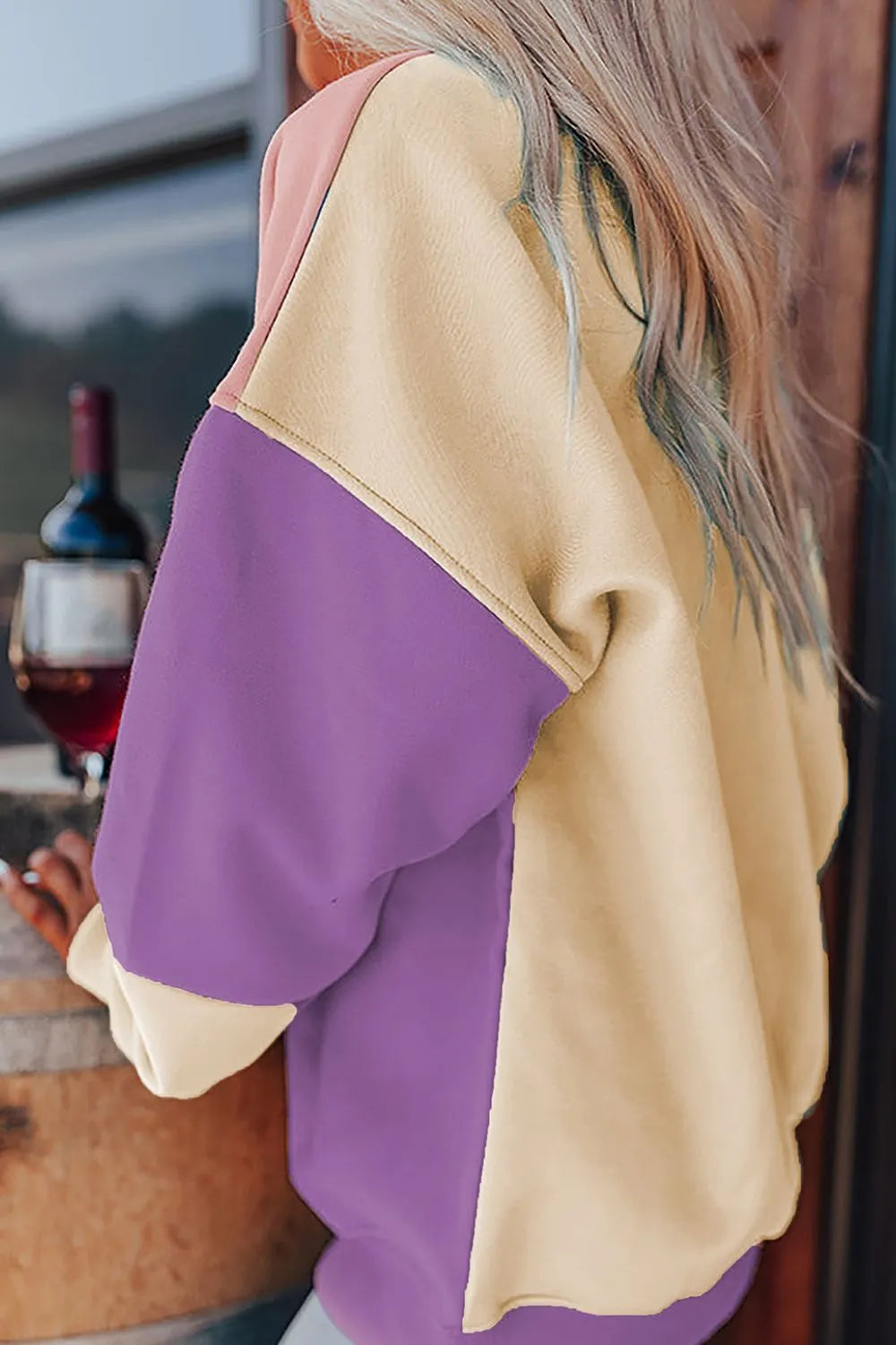 Side view of cream and purple color-block sweatshirt