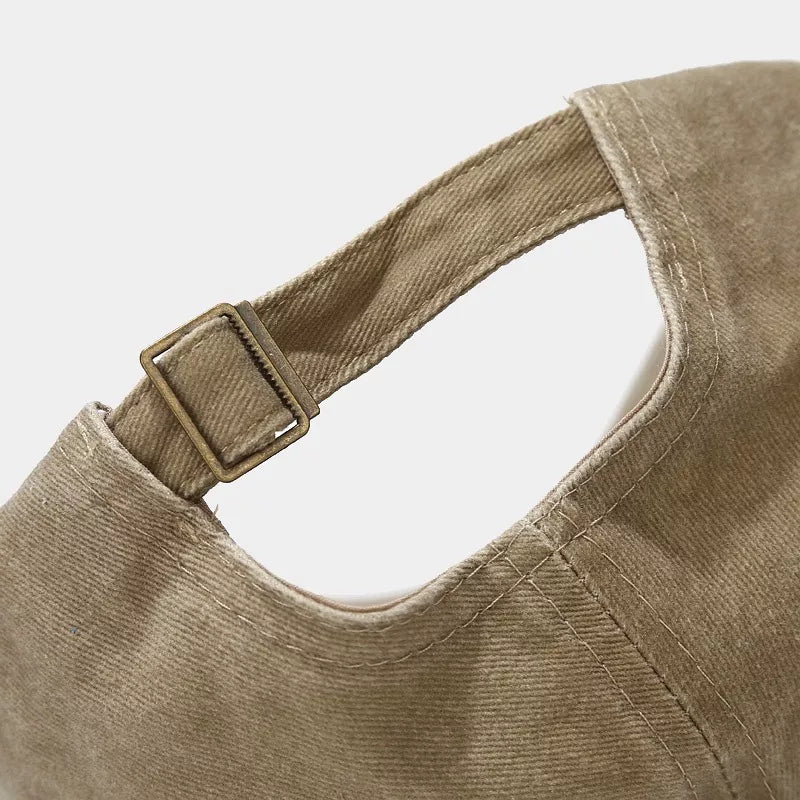 Back view of the khaki baseball cap showing the adjustable strap