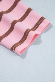 Folded pink striped fabric showing the stripe pattern.