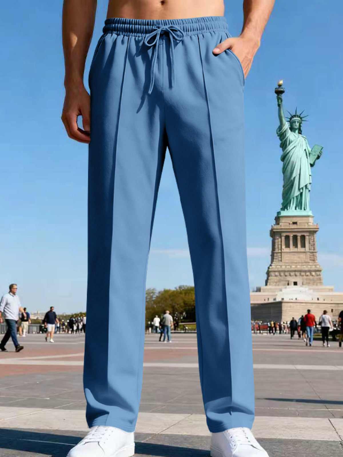 Front view of light blue straight-leg pants near the Statue of Liberty.