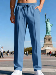 Front view of light blue straight-leg pants near the Statue of Liberty.