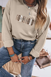 Front view of beige sweatshirt styled with jeans and handbag