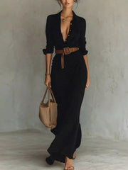 Front view of the black long-sleeve shirt maxi dress with a brown belt.
