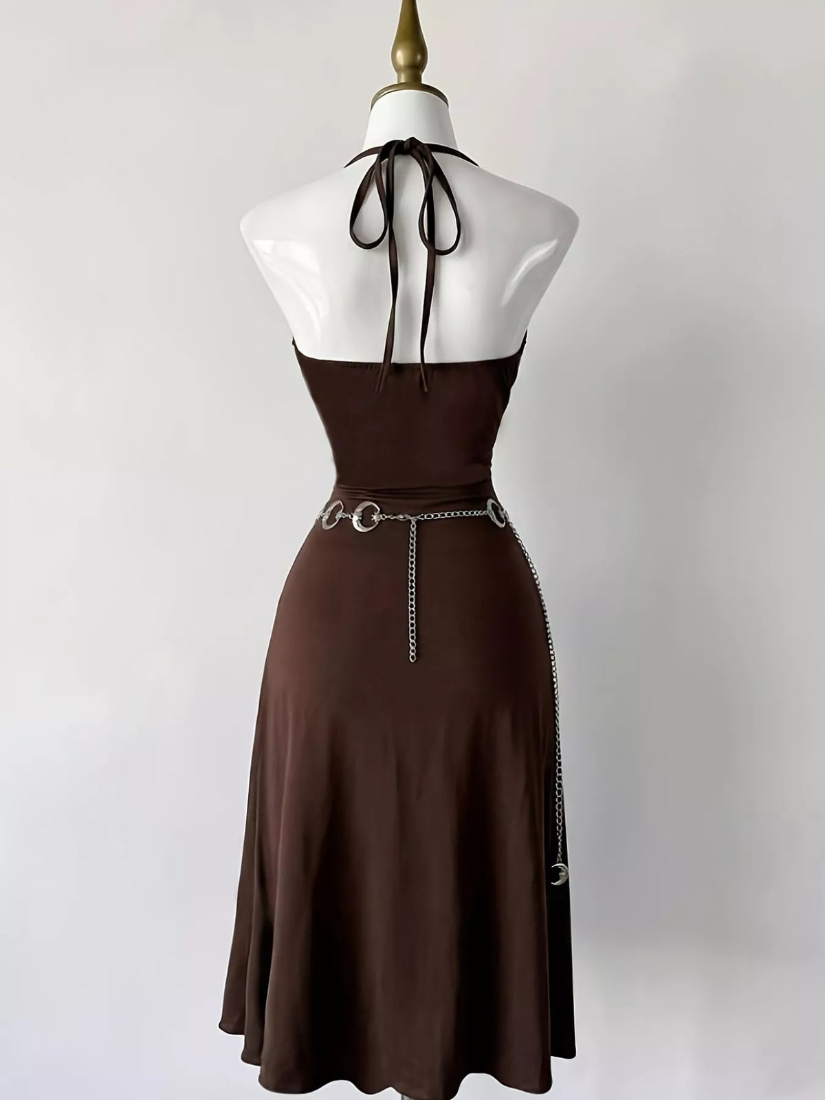 Back view of dark-brown halter dress with tie straps and open back