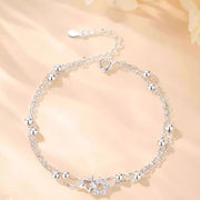 Silver star bracelet arranged in a circle with ball accents