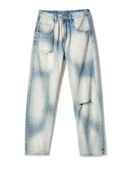 Light-wash distressed jeans laid flat, front view