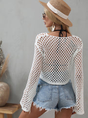 Back view of the white openwork cropped cover-up with flared sleeves.