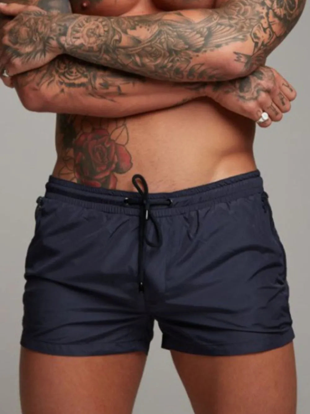 Model wearing navy drawstring active shorts, front view