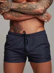 Model wearing navy drawstring active shorts, front view