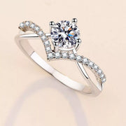 Close view of the blue rectangular stone and prong setting held between fingers.