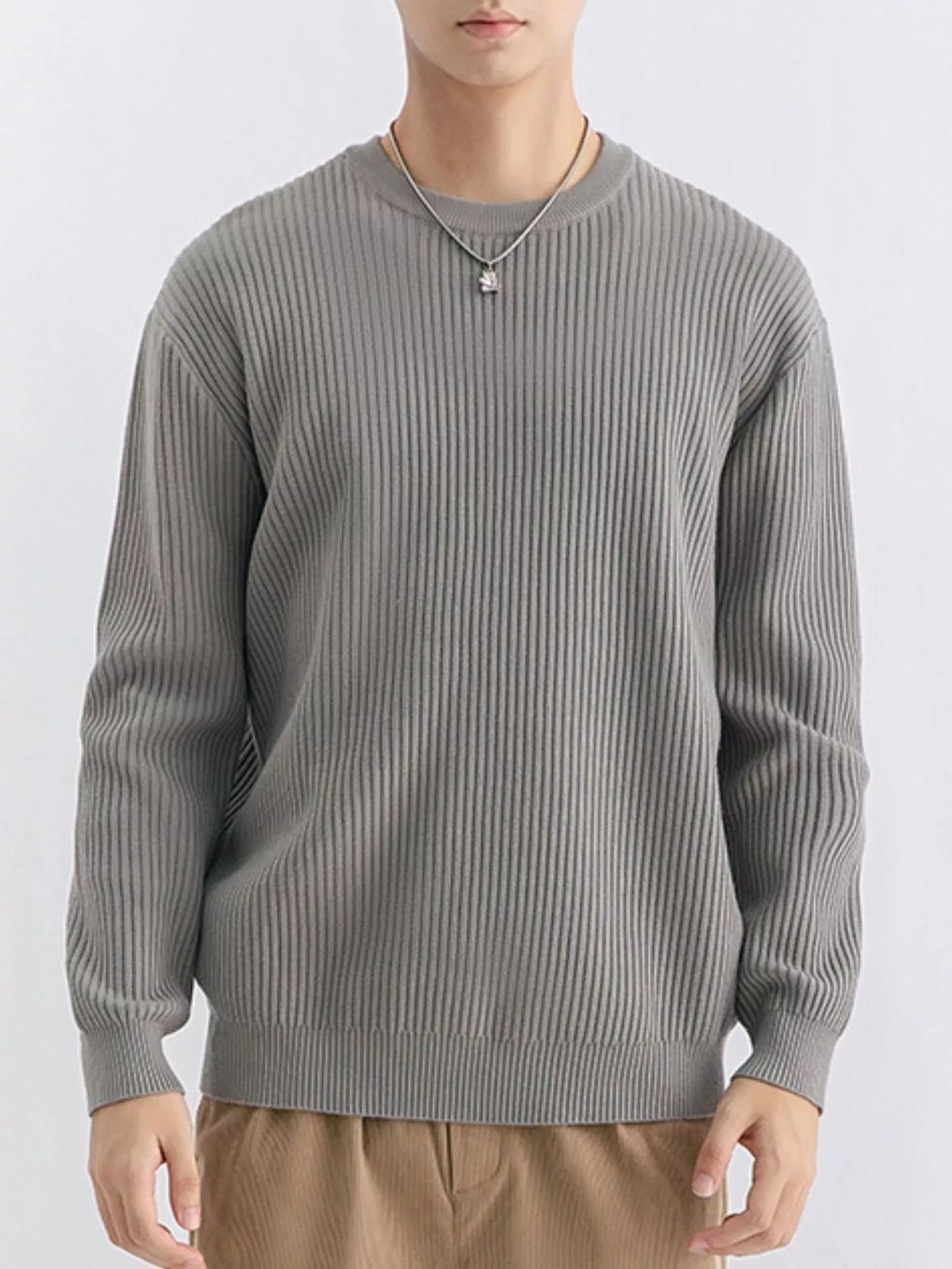 Front view of medium grey ribbed sweater showing long sleeves and straight ribbed hem
