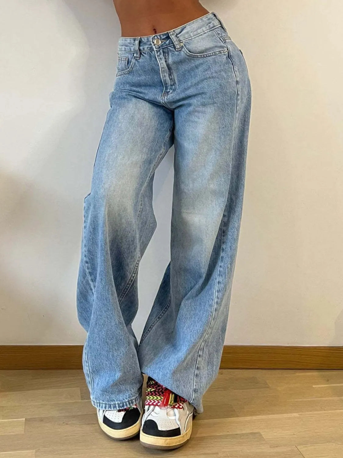 Light blue wide-leg jeans shown from the front with waistband and pockets visible