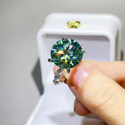 Front close-up of green-blue round centre stone and side accents