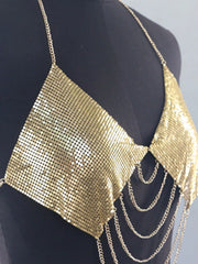 Close view of gold chainmail panels and layered chains