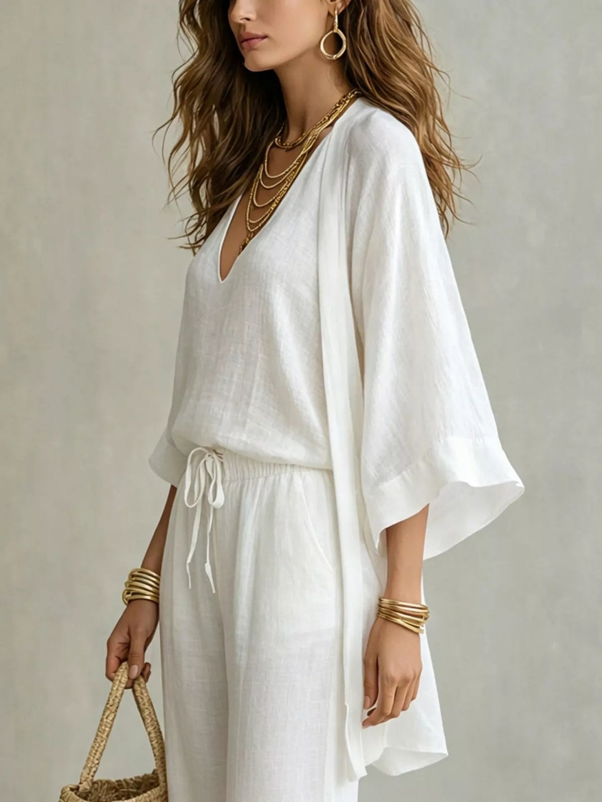 Closer front view of the ivory cardigan set with layered neckline and loose sleeves.