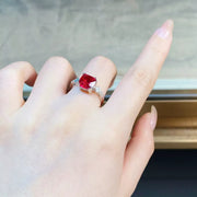 Red centre stone ring shown on a hand from the side.