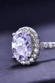 Close view of oval moissanite ring with pavé band