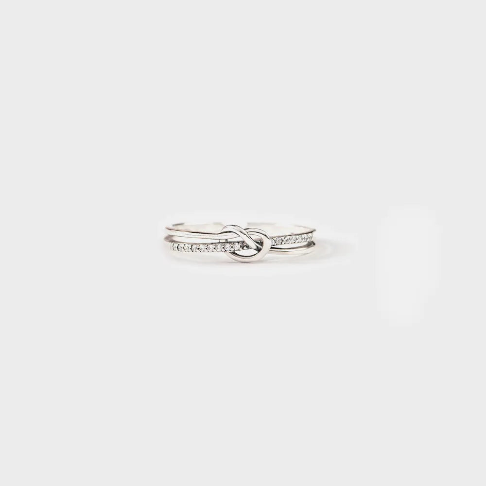 Sterling silver double-layer knot ring on a plain white background