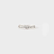 Sterling silver double-layer knot ring on a plain white background