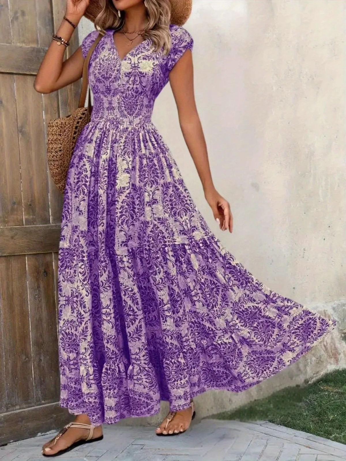 Brown floral maxi dress shown front-on with a full, flared tiered skirt.