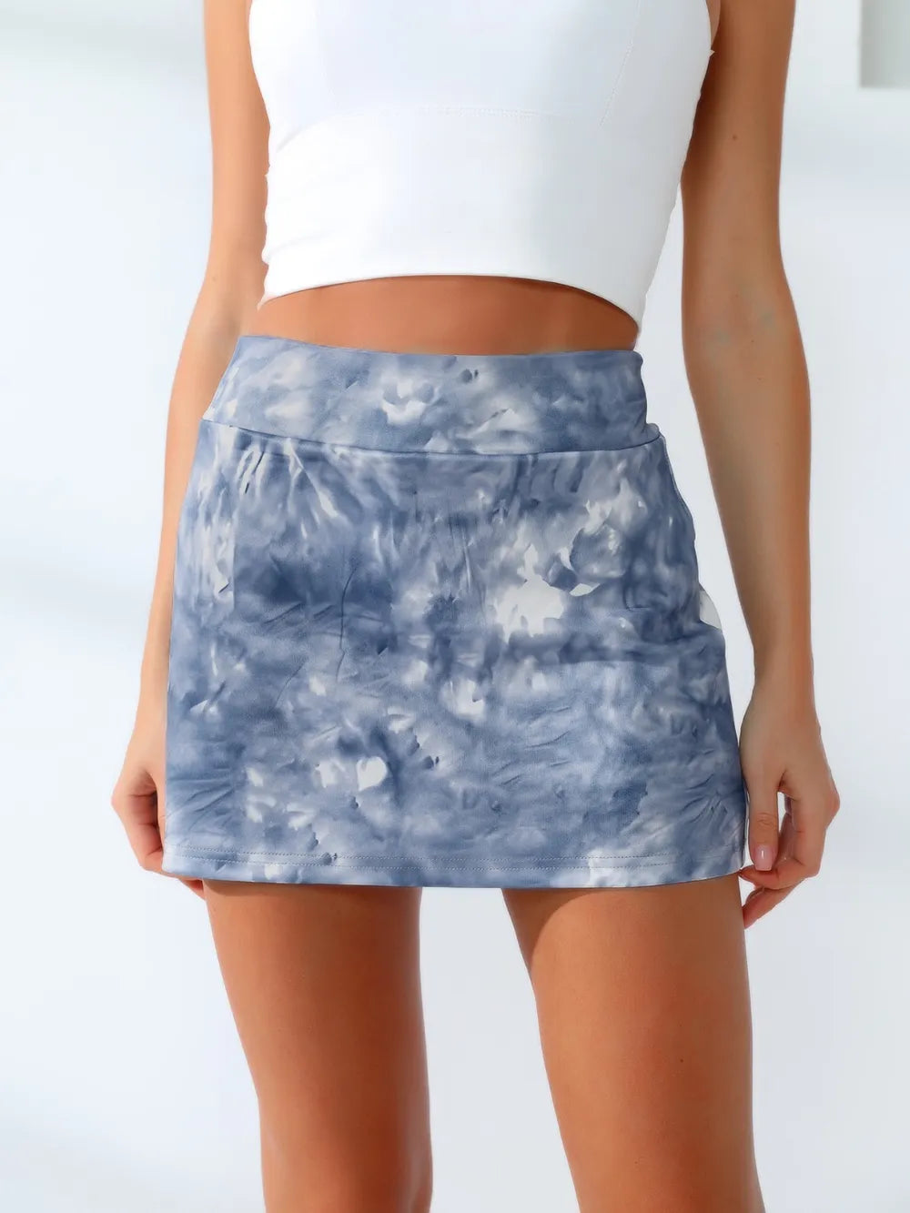 Close view of the wide waistband and blue-gray tie-dye skirt front